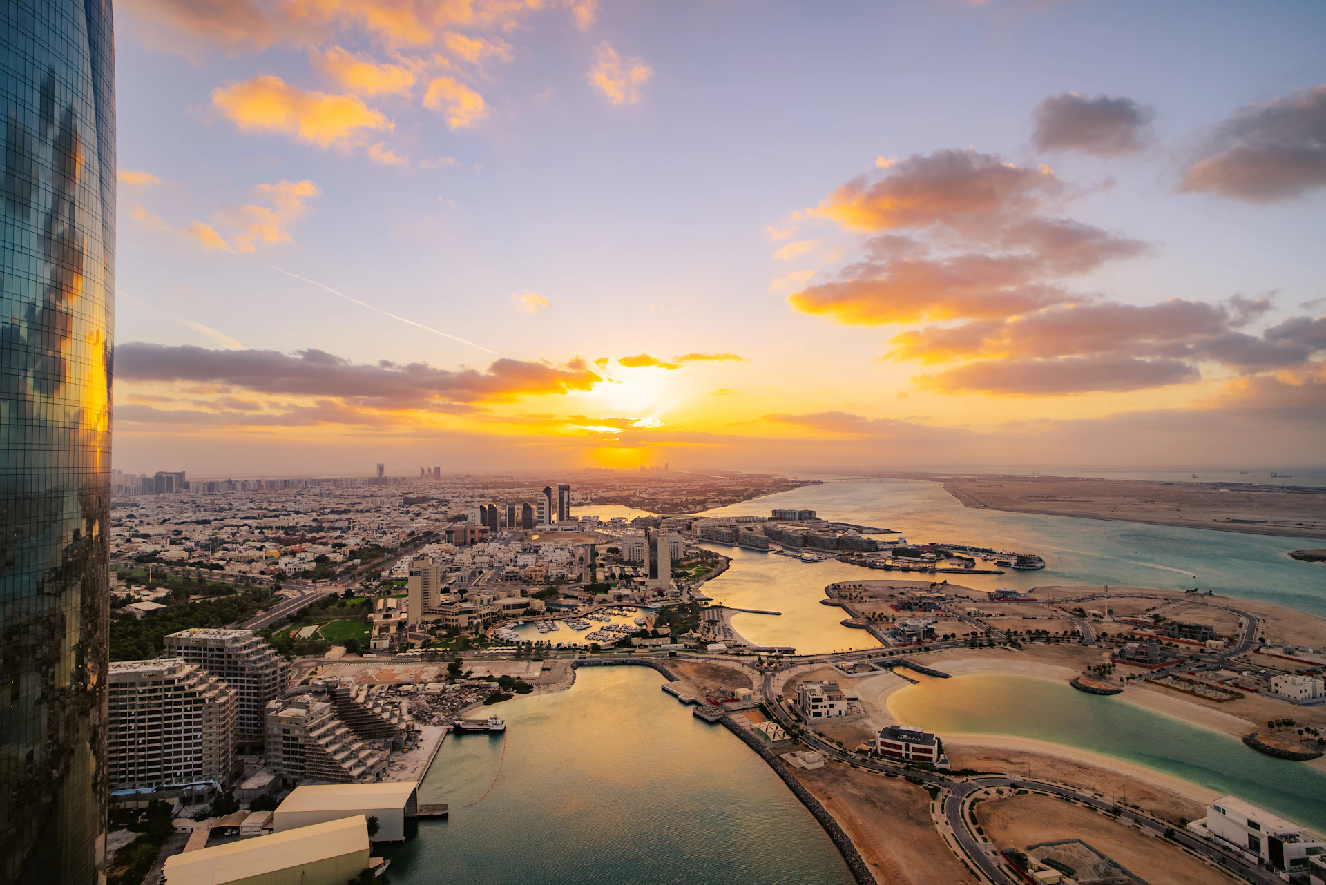 Aerial view of Abu Dhabi waterfront communities at sunset
