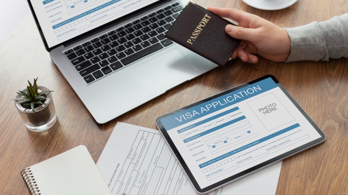 Passport and visa application on a tablet, Golden Visa through property in Abu Dhabi