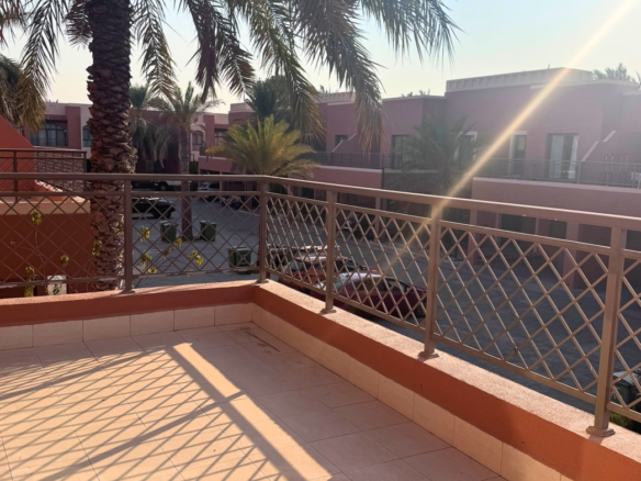 Balcony overlooking palm trees and neighbouring villas in Mangrove Village, Abu Dhabi