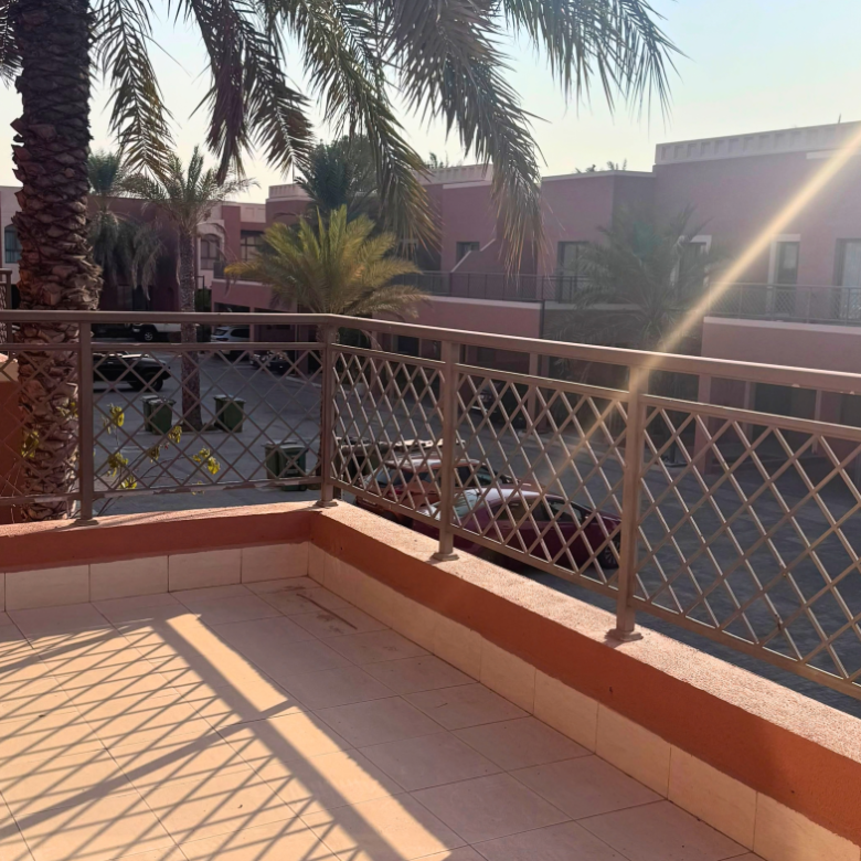 Balcony overlooking palm trees and neighbouring villas in Mangrove Village, Abu Dhabi