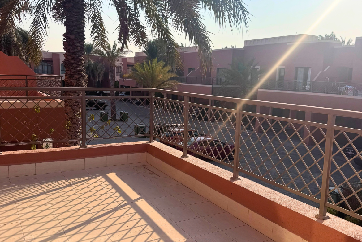 Balcony overlooking palm trees and neighbouring villas in Mangrove Village, Abu Dhabi