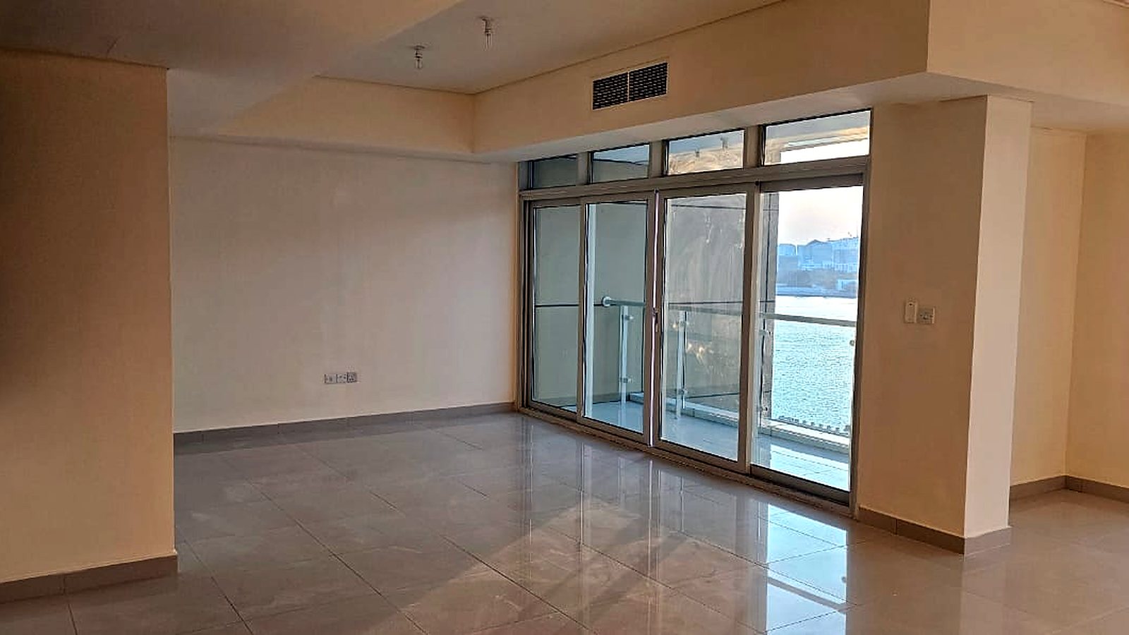 Living room with balcony access and water view, Tala Tower, Marina Square